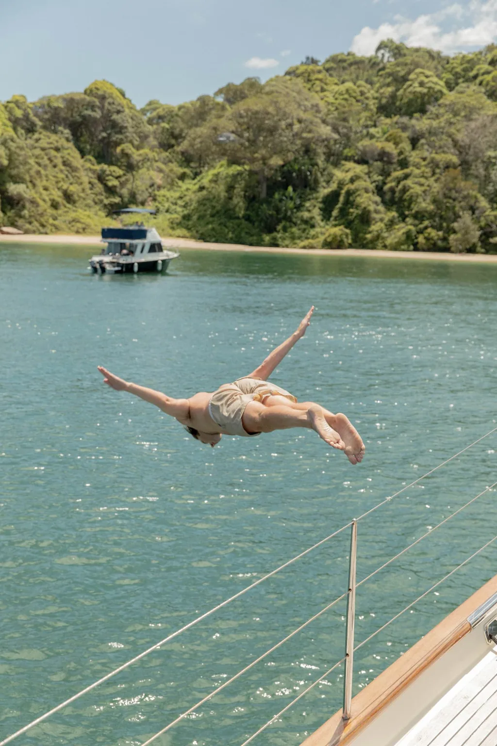 Guest diving from the deck of Sir Thomas Sopwith into a sheltered bay
