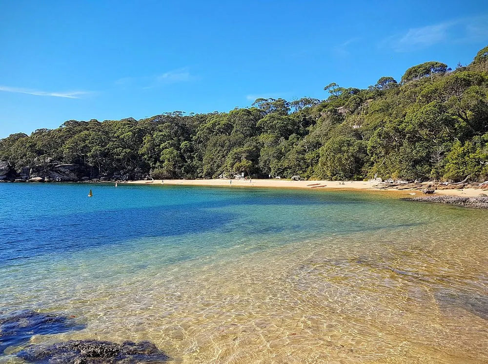 Secluded sandy beach and shallow clear water at Store Beach, North Harbour