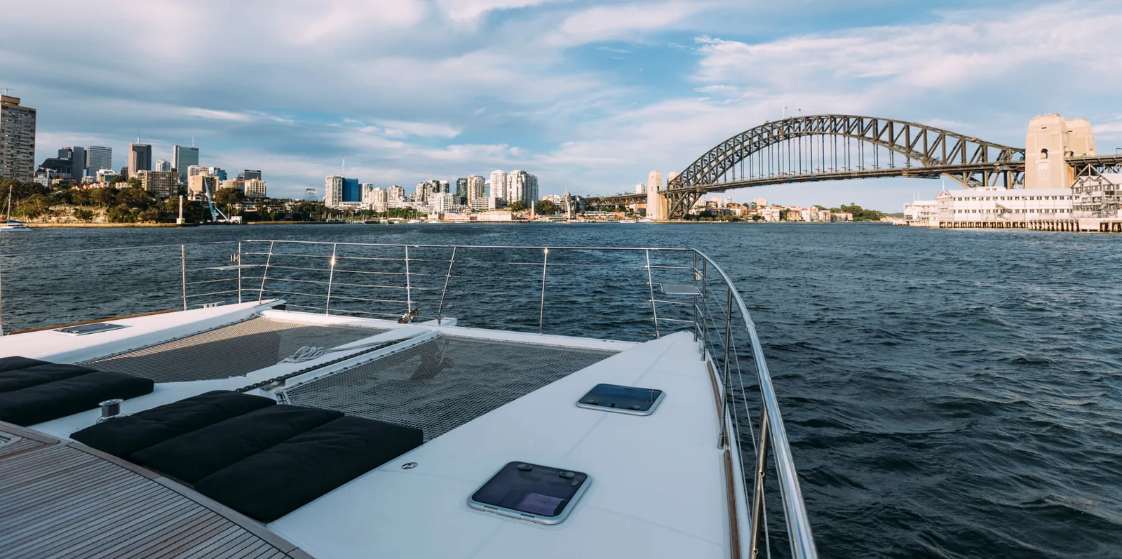 Mon Rêve forward sun lounge and trampoline nets with the Sydney Harbour Bridge beyond