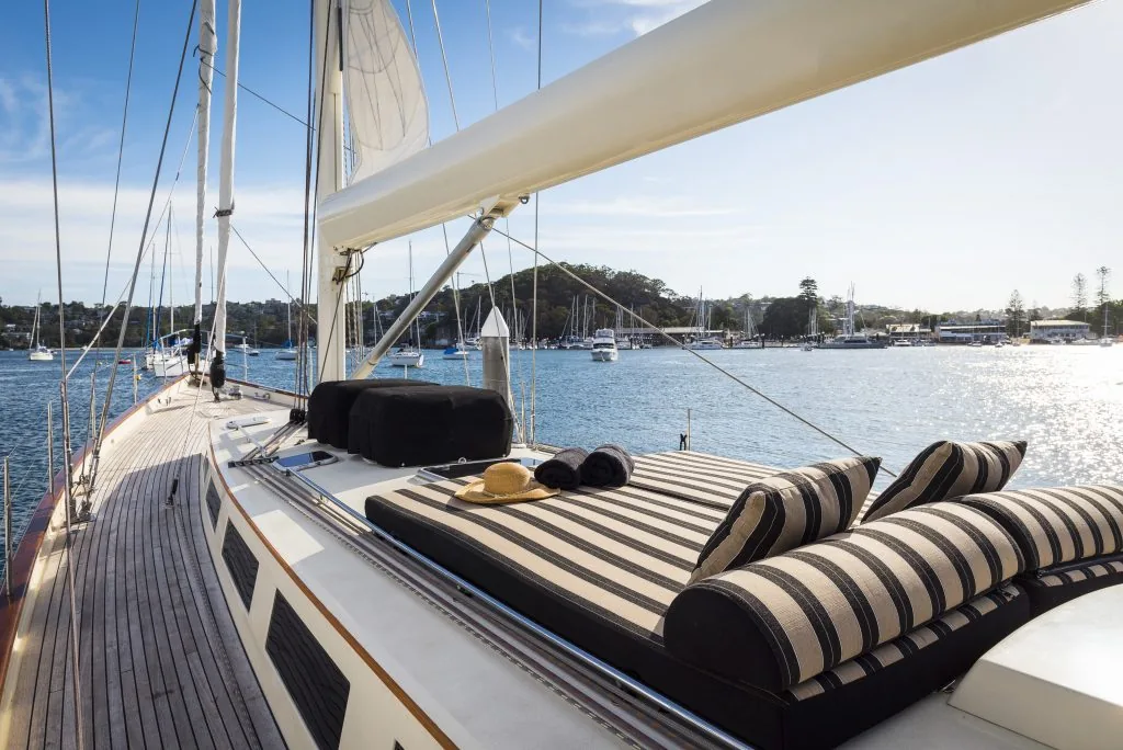 Striped sun cushions laid out on the teak foredeck of Sir Thomas Sopwith
