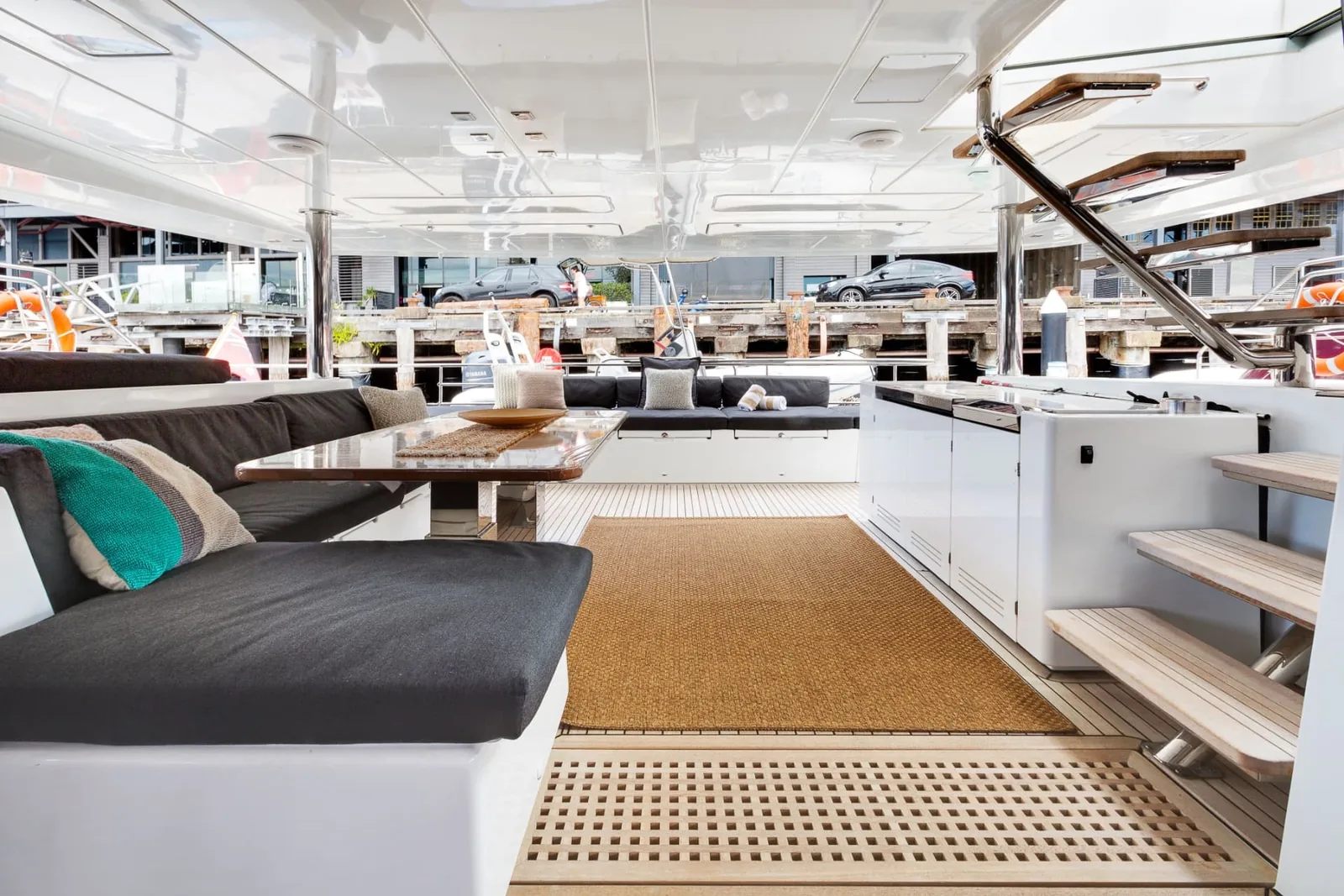 Mon Rêve aft entertainment deck with shaded lounge seating, dining table and wet bar