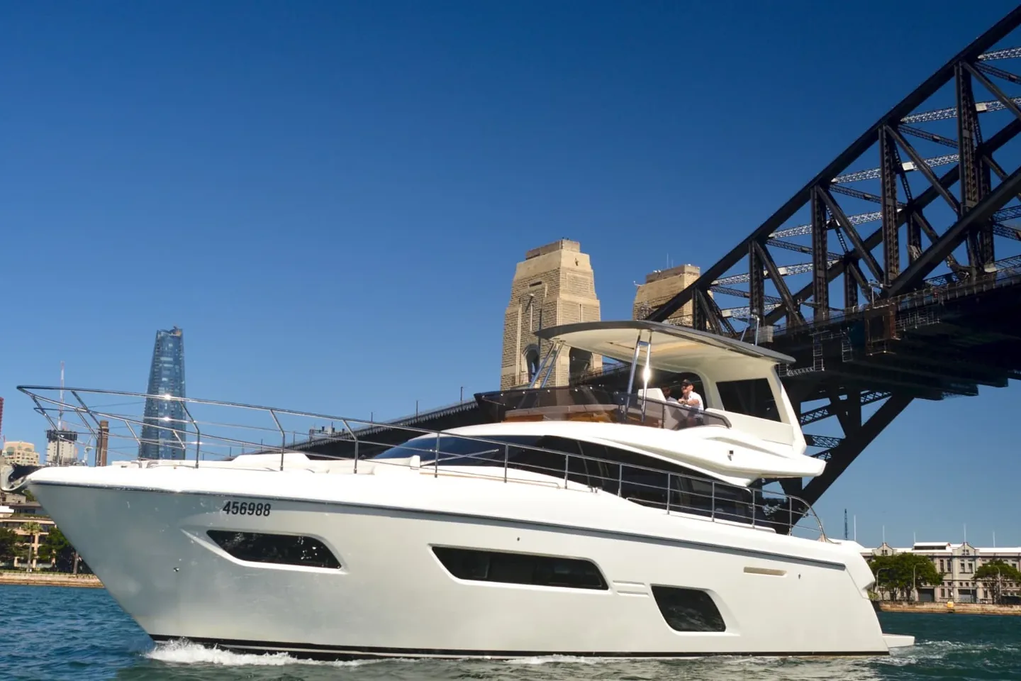 The Ribbon, a Ferretti 550 motor yacht, cruising beneath the Sydney Harbour Bridge