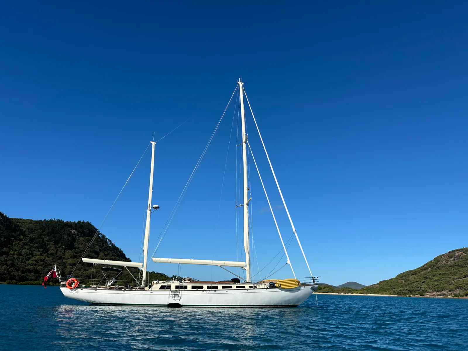 Sir Thomas Sopwith, a 72-foot classic ketch, at anchor in a sheltered bay