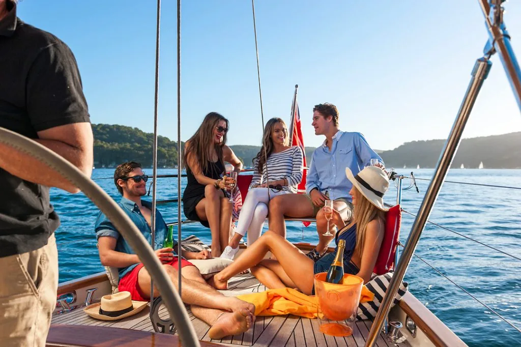 Guests sharing drinks in the cockpit of Sir Thomas Sopwith at anchor