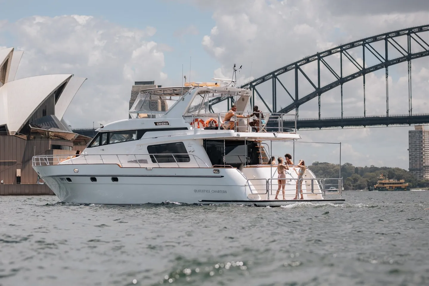 Enigma, a 65ft flybridge cruiser, on Sydney Harbour beside the Opera House and Harbour Bridge