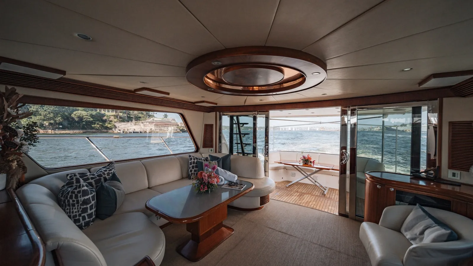 Enigma's saloon with leather lounge seating opening onto the aft deck