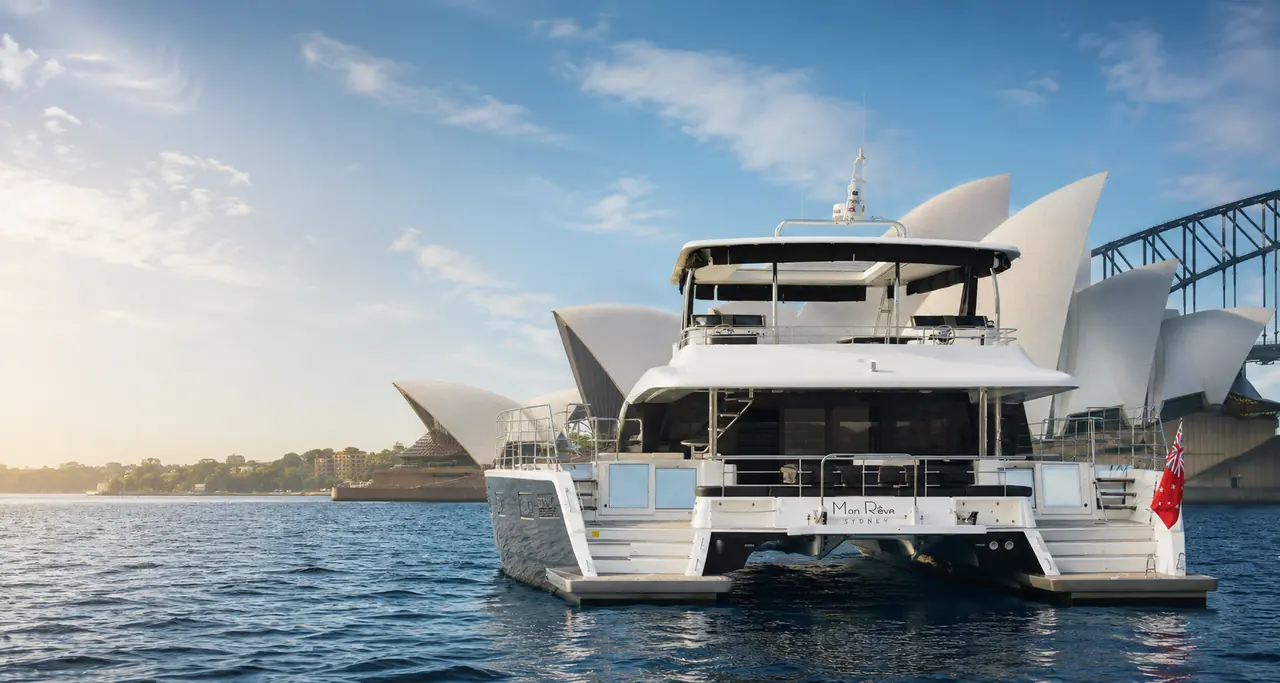 Mon Rêve, a luxury motor yacht, on Sydney Harbour in front of the Sydney Opera House and Harbour Bridge