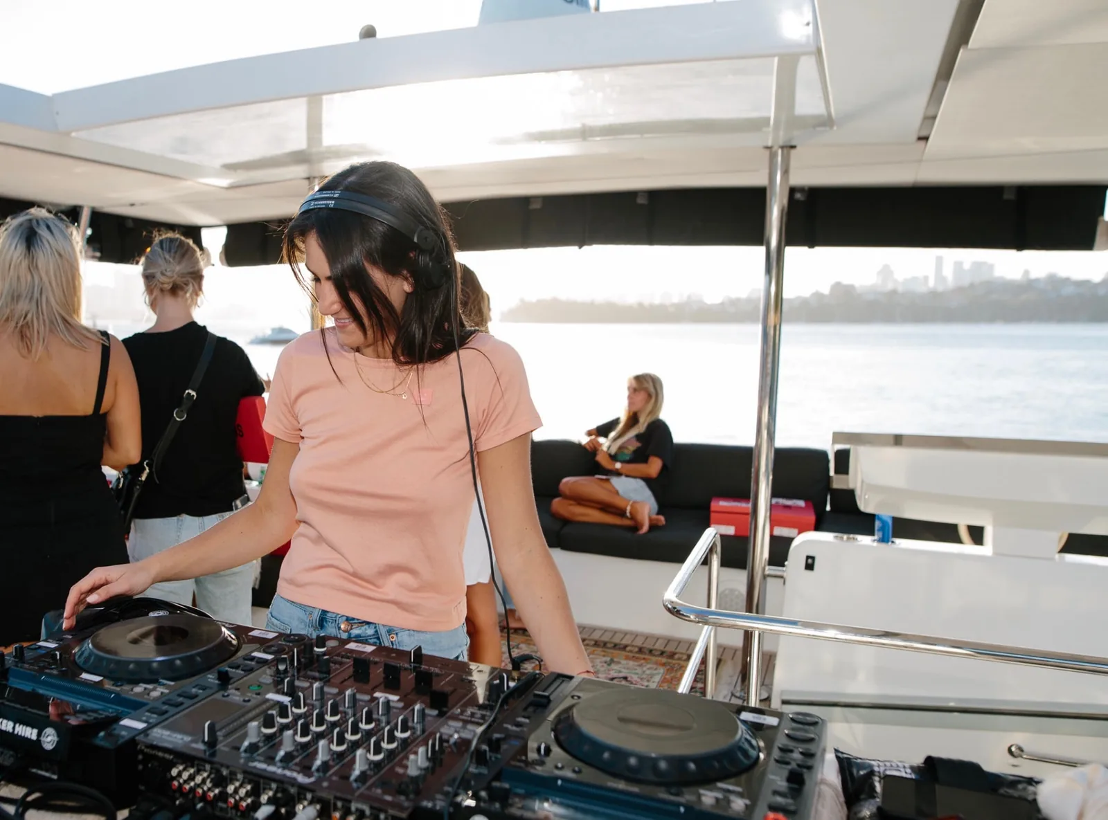 DJ performing aboard Mon Rêve while guests enjoy the harbour charter