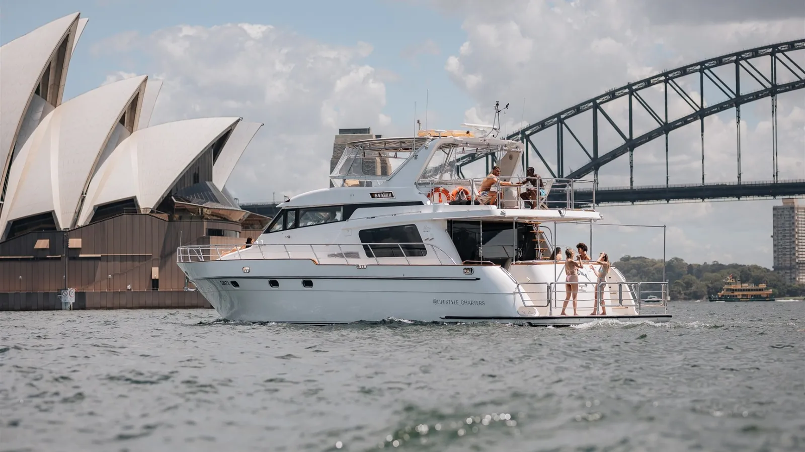 Enigma, a 65ft flybridge cruiser, on Sydney Harbour beside the Opera House and Harbour Bridge